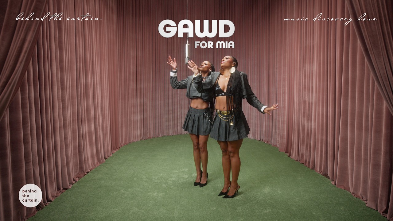 GAWD performing FOR MIA between rose velvet curtains